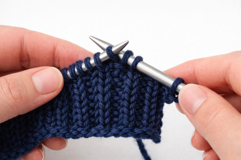 Binding off in pattern on ribbing to maintain consistent knit and purl columns and preserve stretch