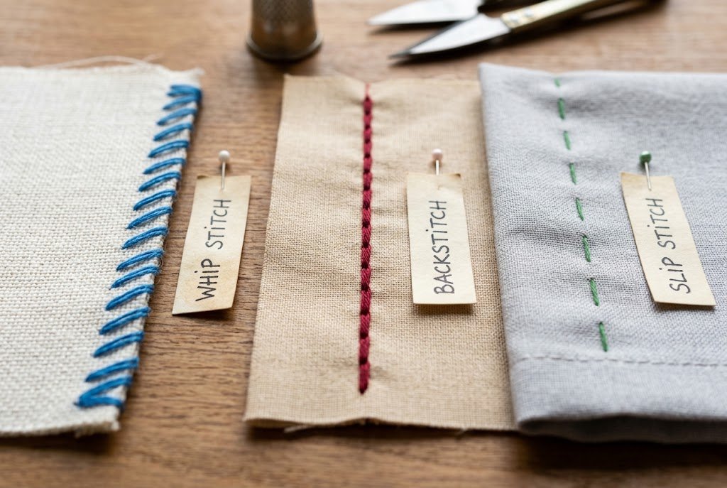 Comparison of whip stitch, backstitch, and slip stitch on fabric swatches