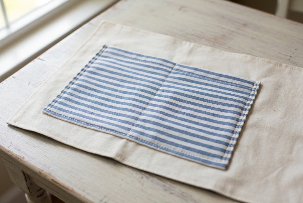 Finished interior pocket topstitched onto tote bag lining fabric with a dividing stitch line