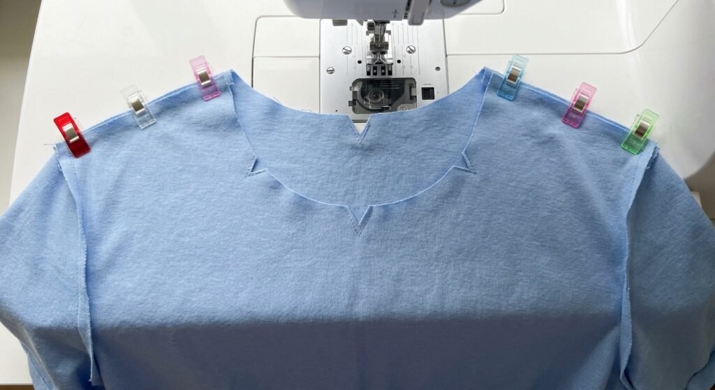 Front and back shirt pieces clipped together at the shoulder seam before sewing
